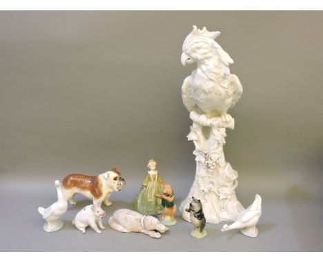 A large white glazed pottery parrot, Royal Worcester grandmother's dress figure, two Nao ducks, three pottery pigs, and a lar