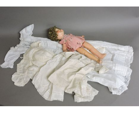 A post war Shirley Temple doll, a Koppelsdorf doll, christening clothes, including a gown, and an 18th century item of child'
