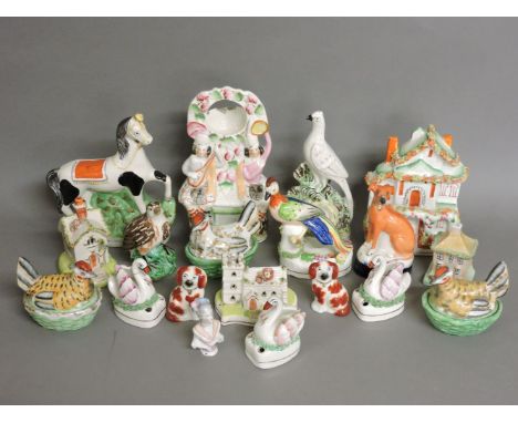 A collection of Staffordshire pottery, a clock group, birds, swans, birds on nests, pastille burners, etc