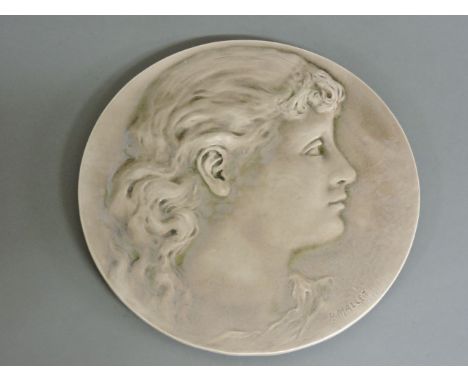A Burmantofts faience pottery roundel, moulded with a portrait silhouette, signed P Mallet, 28cm