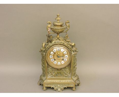 A French decorative brass mantel clock, with eight day striking movement, 36cm high, with key and pendulum