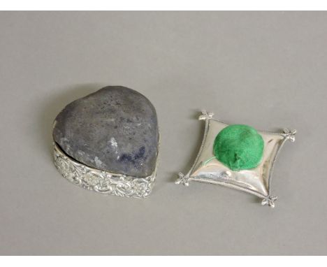 A novelty silver pin cushion, by A & J Zimmerman, Birmingham 1911, 6cm, and another silver heart shaped pin cushion, Birmingh