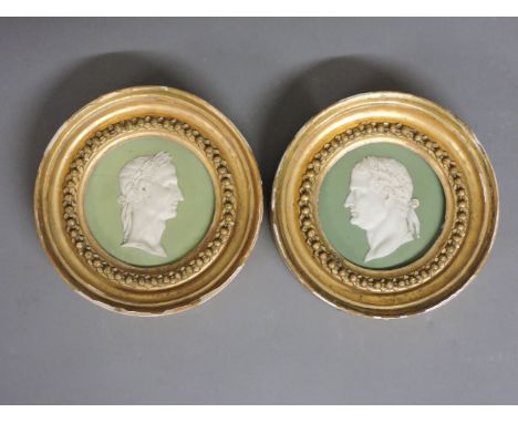 A pair of Wedgwood circular green sage Jasper ware panels, with portrait busts of Julius Caesar and Vitellius, both cracked a