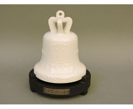 A Berlin KPM porcelain bell, for the 11th Olympic Games in Berlin, inscribed and tubelined with a German eagle and the Brande