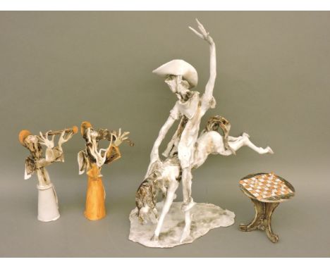 Three abstract clay figures, including a cowboy on horseback, signed Gionnitopani, and another of an angel playing a violin