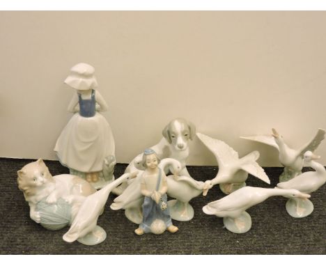 Seven Lladro figures of geese, a Nao dog, cat with a ball of wool, girl with a dog, and a clown