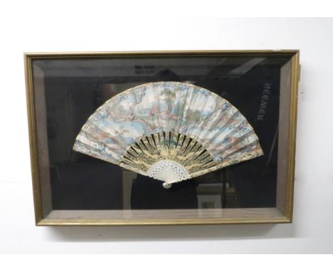 A FRAMED 18TH CENTURY FAN the leaf painted with rococo scrolling vignettes depicting courting couples, with gilt and floral b