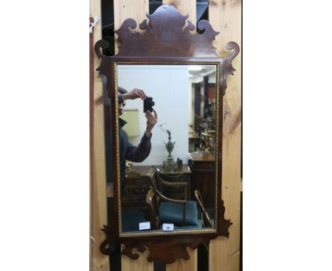 A mahogany framed Georgian style wall mirror, two tier occasional table, strung footstool, carved sewing box and a ceramic um