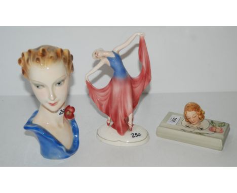 An Art Deco Goebel bust of a woman, a Katzhutte dancing girl and a pottery pen rest modelled with the head of a girl Conditio