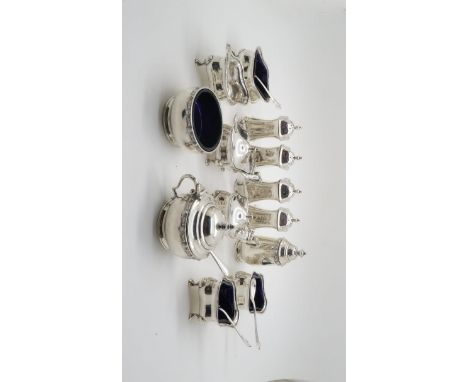 A collection of silver condiment pots, pepperettes and salts, the pots of shaped diamond form with blue glass liners,, by Jam