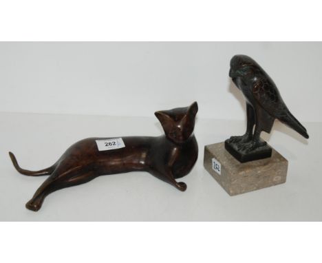 A Egyptian revival style bronze of a hawk on marble base together with a bronze cat Condition Report:Available upon request