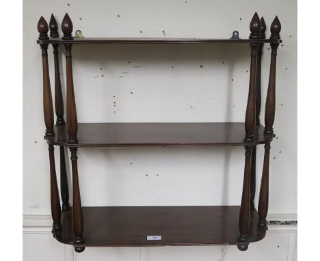 A Victorian mahogany three tier wall shelf and two upholstered footstools (3) Condition Report:Available upon request