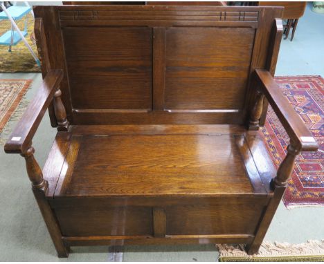 A 20th century oak monks bench with turned uprights, 97cm high x 100cm wide x 95cm deep Condition Report:Available upon reque