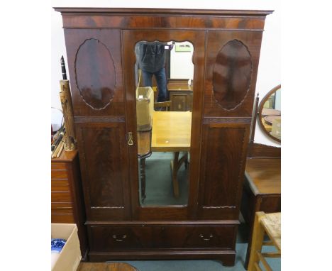 A Victorian mahogany bedroom suite consisting mirrored door wardrobe, mirror back dressing table and a marble top wash stand 