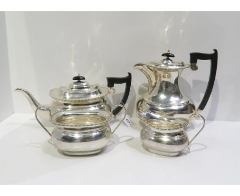 A four piece silver tea service, comprising tea pot, coffee pot, sugar bowl and cream jug, with beaded rims and ebonised wood