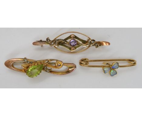 A 15ct gold opal set shamrock brooch, length 3.5cm, weight 2.1gms. A 9ct gold green glass and pearl brooch, length 3.9cm, and