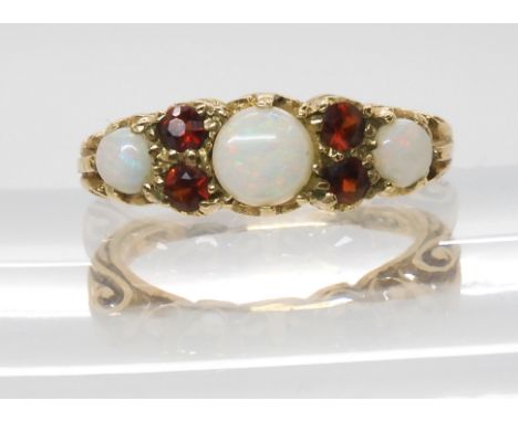 A 9ct gold opal and garnet cluster ring with scrolled mount, size M1/2, weight 3.1gms Condition Report:Available upon request