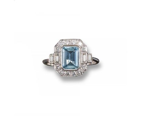 An aquamarine and diamond cluster ring, the emerald-cut aquamarine is set within a surround of circular-cut diamonds and bagu