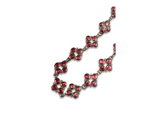 A George III garnet cluster necklace, set with 12 garnets (one replaced, some damaged) in closed back gilt metal mounts. Fitt