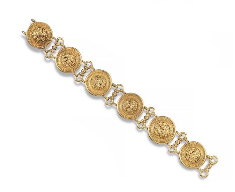 A gold bracelet by Castellani, circa 1860. Formed with six circular discs, each centred with a 'millefiori' cluster within su