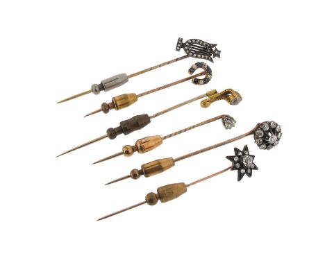 A gold stick pin mounted with a diamond-set star, a gold stick pin mounted with a diamond-set cluster, a gold stick pin mount