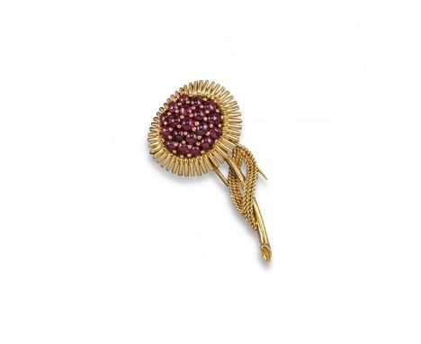 A ruby and diamond brooch circa 1970, the stylised textured gold brooch set with circular-cut rubies and diamonds. 4.5cm wide