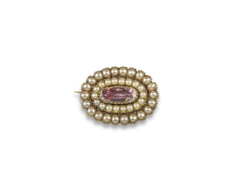 An early 19th century pink topaz, seed pearl and gold locket brooch, the long oval-shaped foil-backed topaz is set within two
