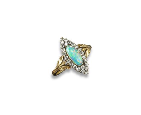 A late Victorian lozenge-shaped opal and diamond cluster ring, the oval-shaped opal is set within a surround of old circular-