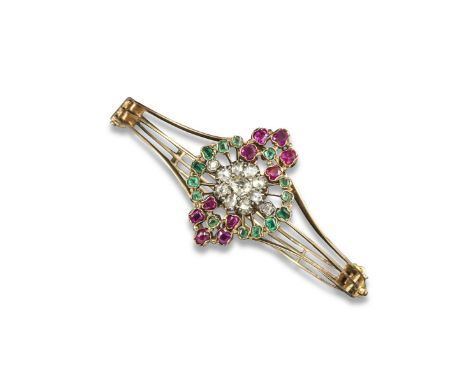 A Victorian gem-set hinged bangle, centred with a cluster of rose-cut diamonds within a surround of emeralds and rubies. Fitt