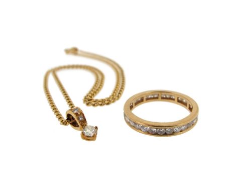 A diamond set gold full circle eternity ring, size K 1/2. With a diamond pendant on a fine link gold neck chain.