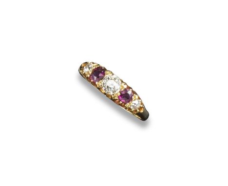 An early 20th century diamond and ruby five stone ring, set with three graduated old circular-cut diamonds and two oval-shape