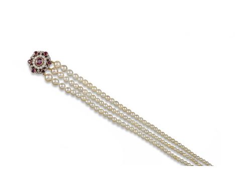 A three row cultured pearl necklace, with a Victorian ruby and diamond cluster clasp. 36cm longest.