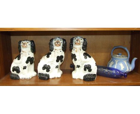 Three Staffordshire black and white spaniel ornaments, 26cm, a blue glass rolling pin, 38cm long and a blue jasperware teapot