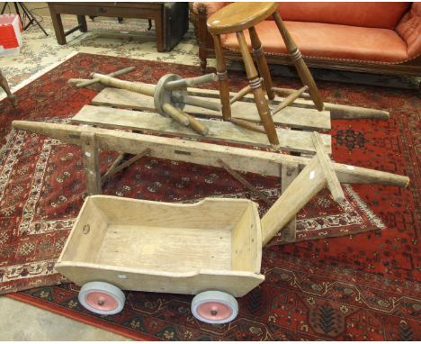 A pine pig truckle, 170 x 57cm, a washing dolly, a stool and a trolley, (4). 