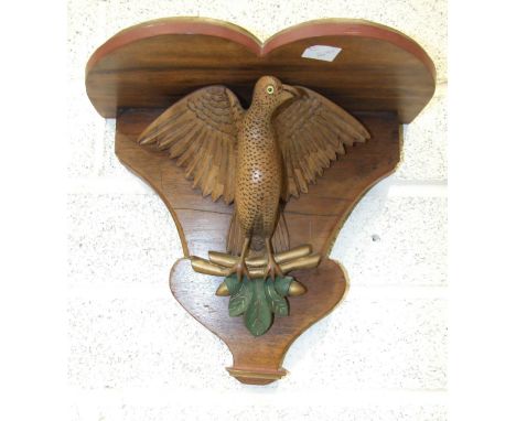 A Continental carved wood clock bracket supported by a carved wood winged bird, (later painted), a 19th century gilt metal fi