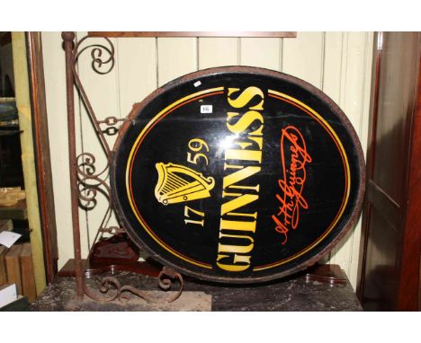 Large illuminated Guinness pub sign with wrought iron bracket