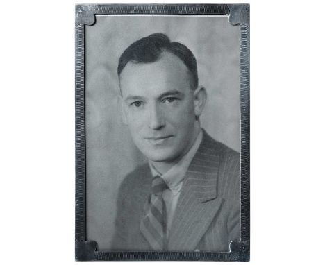 An engine turned silver photograph frame Hallmarked Birmingham 1925.The wooden back with easel support.Size overall 30 x 20.5
