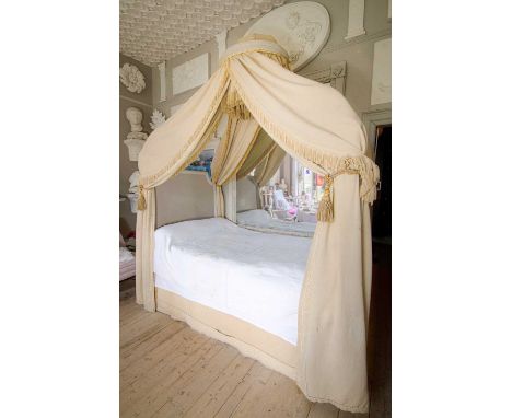 A canopied bed with sumptuous hangings from Tyttenhanger House  The silk and cotton manilla hangings bordered with Greek-key 