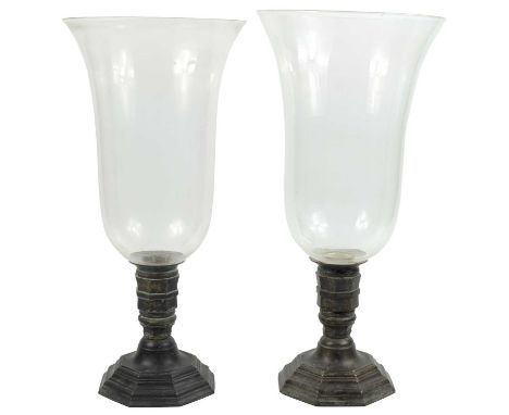 A pair of brass candlesticks with  enormous bell shaped glass shades With octagonal base, width 14cm and round section top. H