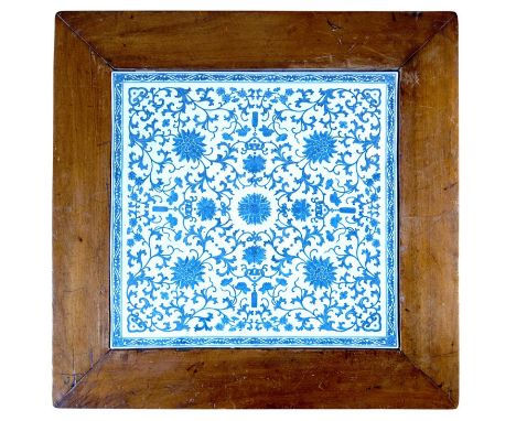 A square Chinese porcelain Ming-style tile Decorated with underglazed blue chrysanthmums, arabesques and tassels.52cm. Set in