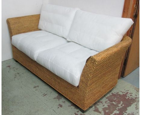 BELTON SOFA, three seater, in a plaited and woven water hyacinth finish with lacquered black feet, 215cm L x 87cm D x 77cm H.