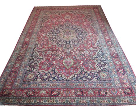 ANTIQUE TABRIZ CARPET, 477cm x 313cm, midnight blue medallion on a terracotta palmette and vine field within corresponding sp