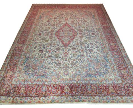 FINE KERMAN LAVER CARPET, 430cm x 315cm, of scrolling vines around a ruby medallion, on ivory field and corresponding border.