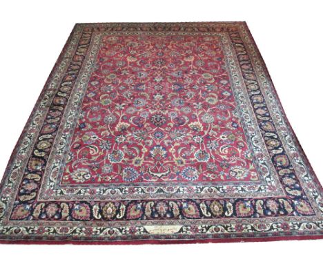 VINTAGE SIGNED TABRIZ CARPET, 380cm x 294cm, all over vine and palmette design on a ruby field within a midnight blue repeat 