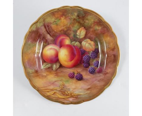 A Royal Worcester cabinet plate, decorated with fruit to a mossy background by H H Price, to a shaped gilt edge, diameter 9in