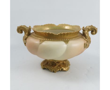 A Royal Worcester blush ivory bowl, with gilt rim and handles, shape number 1459, circa 1903, diameter approximately 12insCon