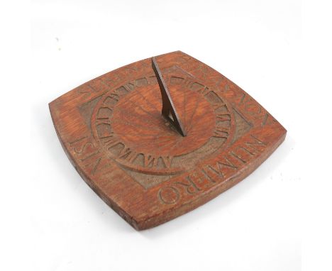 An Arts and Crafts carved oak wall sundial, with copper gnomon, 12ins square
