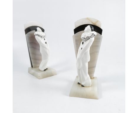 A pair of Royal Worcester art deco Pierrot bookends, modelled by Doris Lindner, the black and white figures mounted on matchi