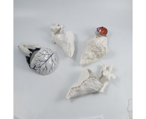 Four Royal Worcester wall pockets, or hair tidies, comprising a Lovebirds pocket in blue and white, shape 587, dated 1880, a 