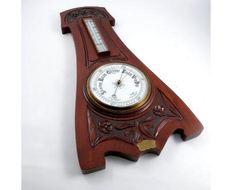 A mahogany cased aneroid barometer, with mercury filled thermometer, the case carved in the Art Nouveau style, with presentat
